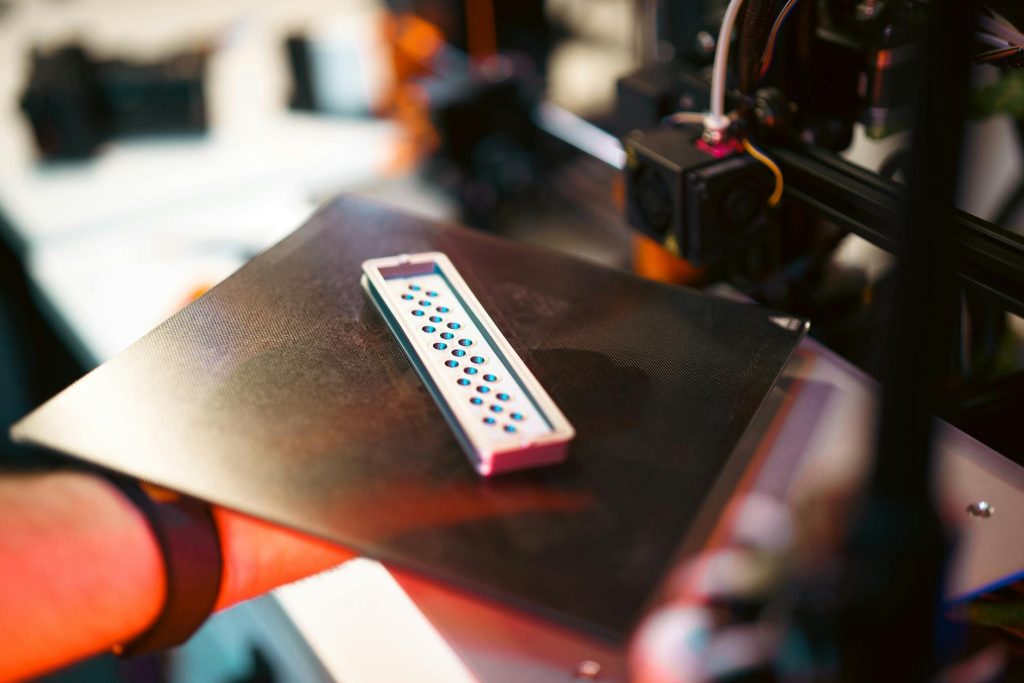 A skilled engineer carefully examining a 3D printed prototype in a modern production facility, reflecting 3DAgency's commitment to quality and precision